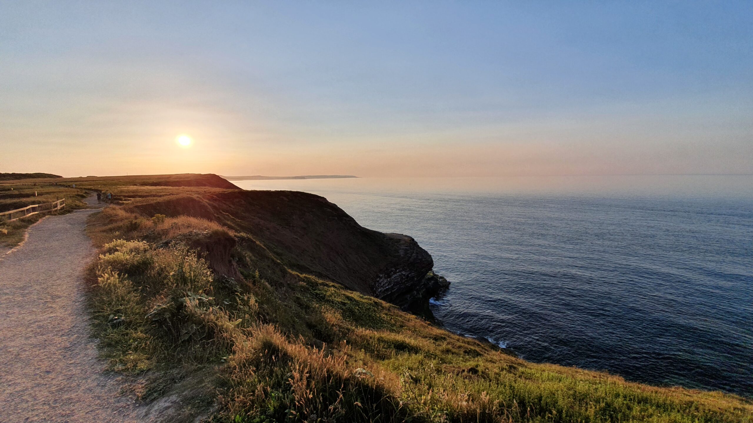 Cliffs above a calm sea at sunset